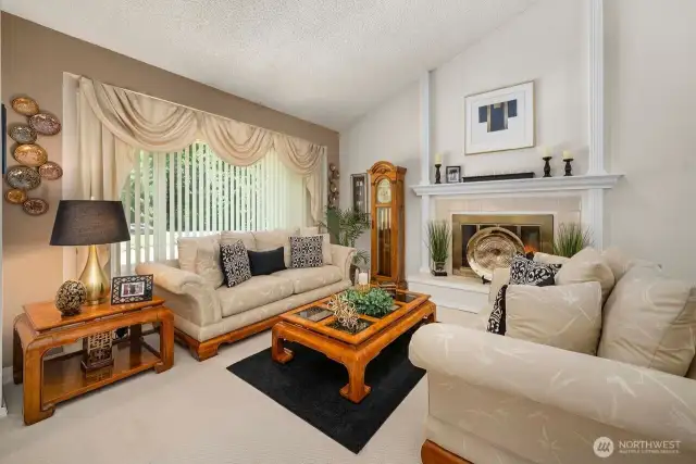 Vaulted ceilings, gas fireplace with beautiful raised hearth surround adds to the charm that you could make your own.