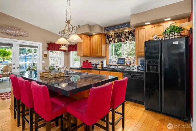 Sit around this 8 foot island, have a cup of coffee and talk about your day or walk thru the double doors and enjoy your huge covered deck.