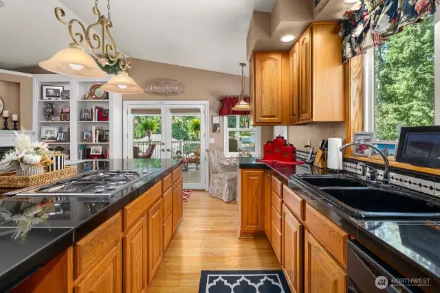 Spacious kitchen with plenty of counter space and cabinets is located right off the covered deck, a perfect place to entertain.