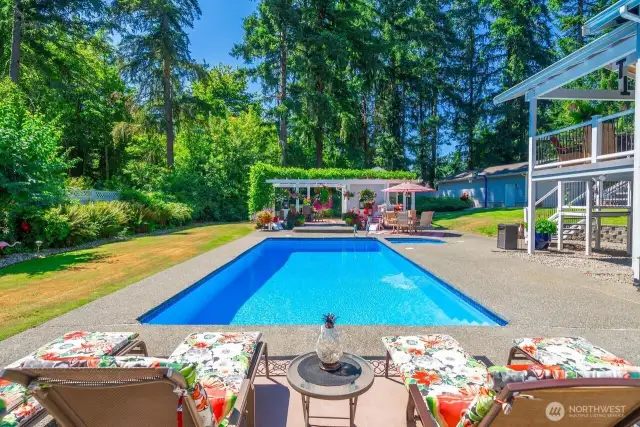 This tranquil space is like a resort with its lush landscaping and crystal clear pool and built in hot tub.