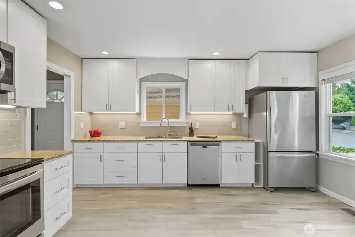 Spacious kitchen with porcelain tile flooring and room to cook, gather, and enjoy