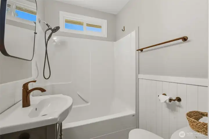 Updated bathroom featuring new sink, beadboard and light fixture