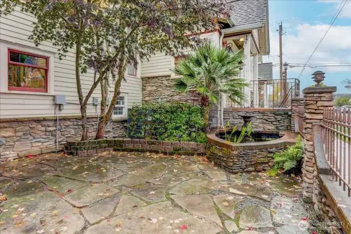 Gated patio with fountain and pond at residential entrance