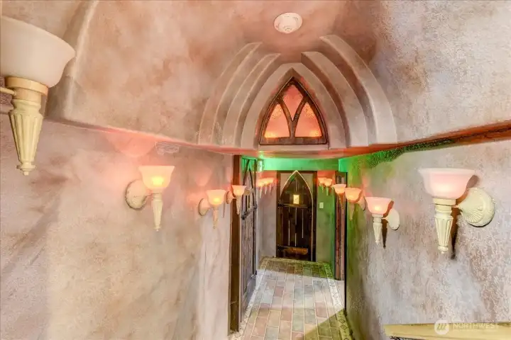 Access to the washer and dryer, additional entertainment room and wine rack and the end of the hallway.