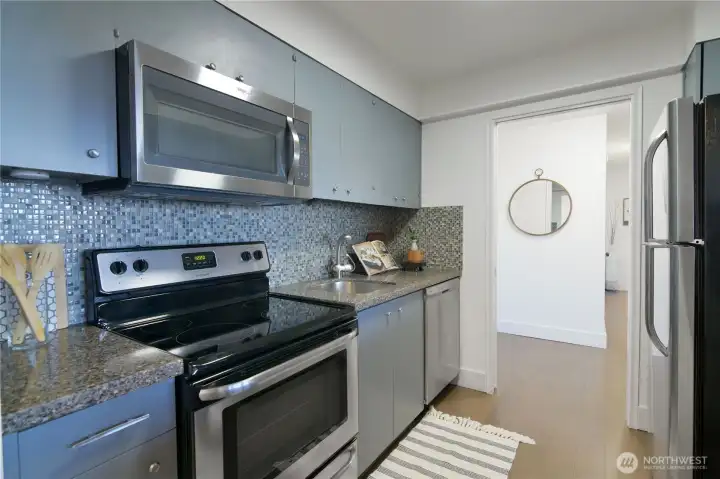 Kitchen features granite countertops and stainless steel appliances