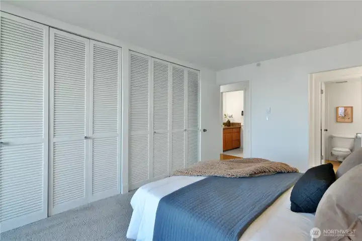 Generous primary bedroom with a wall-to-wall closet