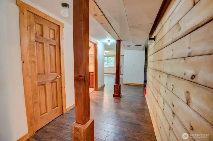 Lower level finished basement - wood-finish support pillars, shiplap wall