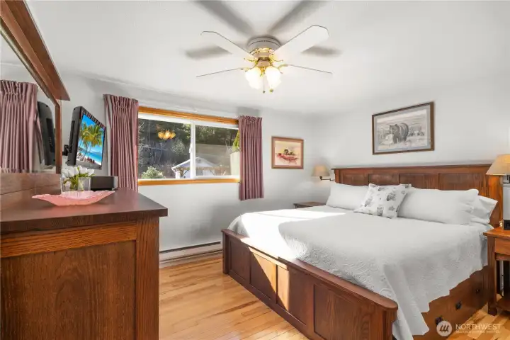 The primary bedroom offers a ceiling fan and views to the backyard.