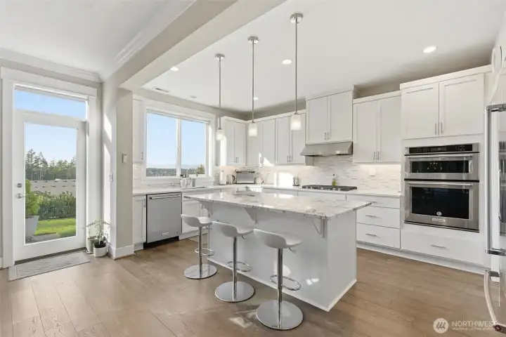 The kitchen features sleek quartz countertops that combine modern elegance with lasting durability. Bright, stylish, and easy to maintain, this space is perfect for both everyday meals and entertaining.