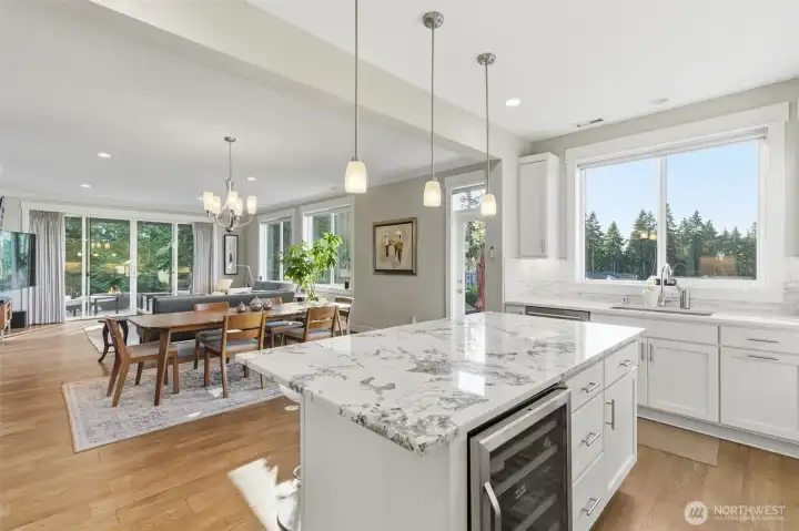 Attention to detail is what you will expect from this residence!  Expansive quarts island with room for informal meals and wine refrigerator located for easy access.