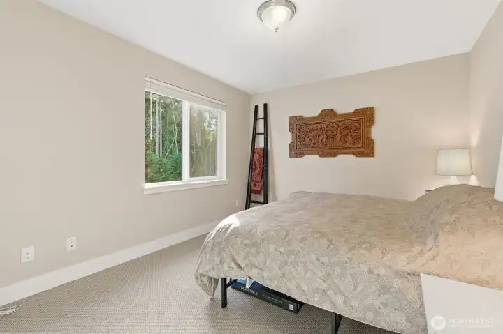 The guest room offers a cozy and inviting space for visitors, thoughtfully designed for comfort and is perfect for family, friends, or overnight stays.