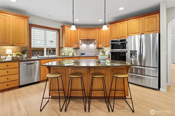 Large granite island, updated appliances - gas Thermador cooktop and convection oven/microwave. Refinished hardwoods & paint/carpet throughout.