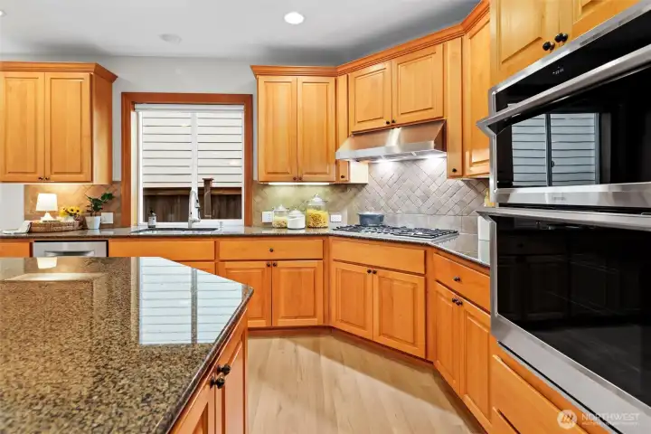 Front living room with gas fireplace, elegant millwork, and abundant natural light.
