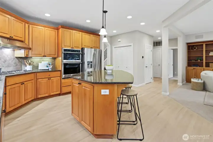 Front living room with gas fireplace, elegant millwork, and abundant natural light.