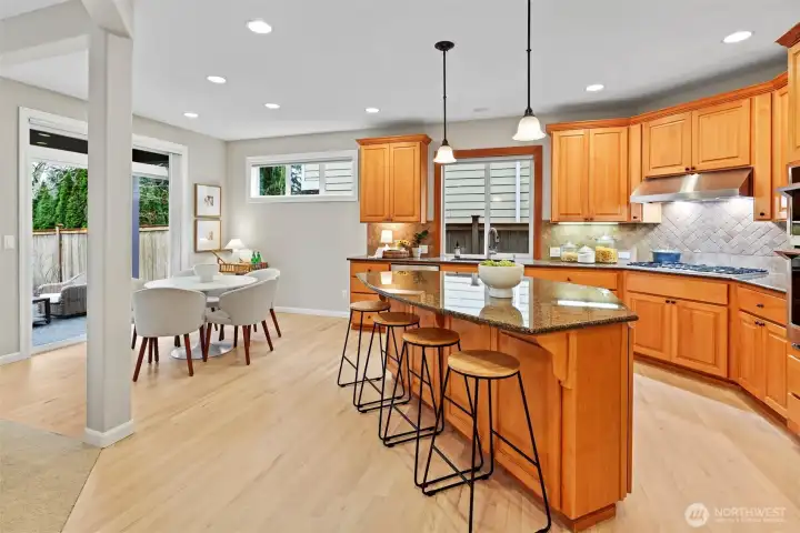 Front living room with gas fireplace, elegant millwork, and abundant natural light.