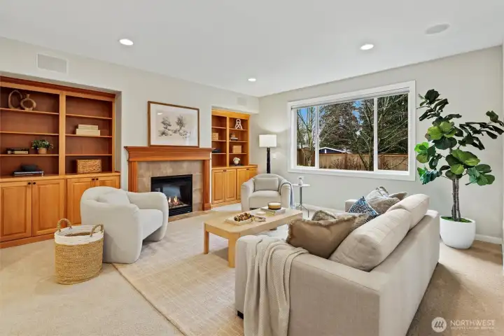Kitchen flows seamlessly into family room with 2nd gas fireplace, built-in cabinetry perfect for storage, and pre-wired in ceiling speakers