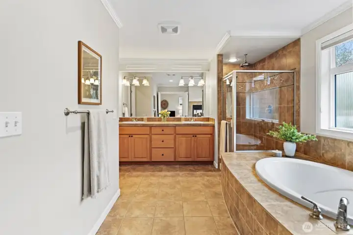 Spa inspired 5-piece ensuite with soaking tub, dual sided fireplace, rain shower head