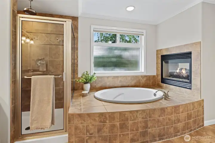 Spa inspired 5-piece ensuite with soaking tub, dual sided fireplace, rain shower head
