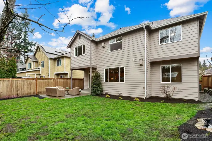 Peaceful fully fenced backyard with curated plants & fruit trees. Grass has been recently seeded.