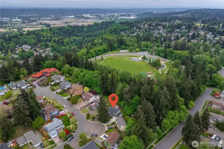 Located next to park with a large lawn, trails, play area, tennis courts, and picnic shelter.