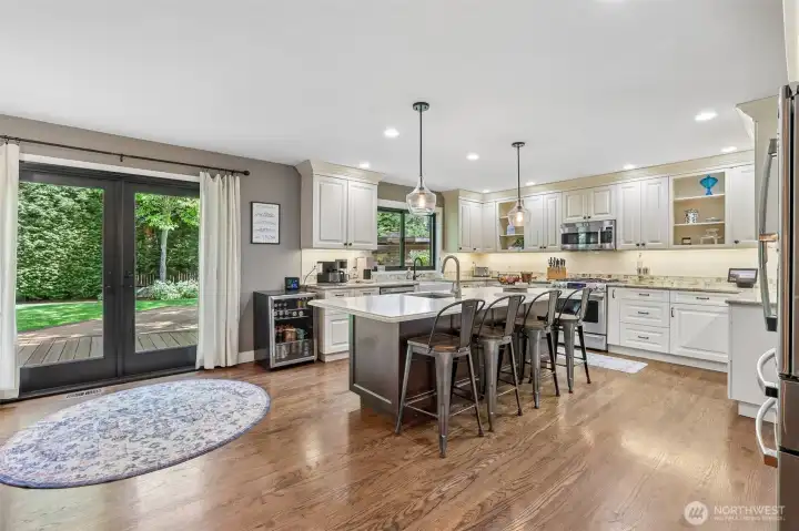 Large kitchen with granite counters. All newer stainless steel appliances with a built in pantry. Large island with breakfast bar. Under cabinet lighting.