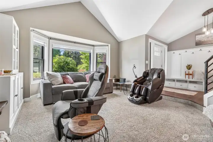 Formal living room with vaulted ceilings and bay window