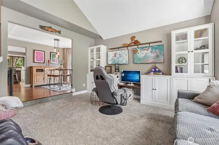 Formal living room with vaulted ceilings and bay window