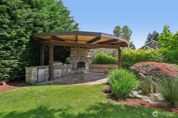 Custom Outdoor kitchen with built in BBQ , fridge and fireplace