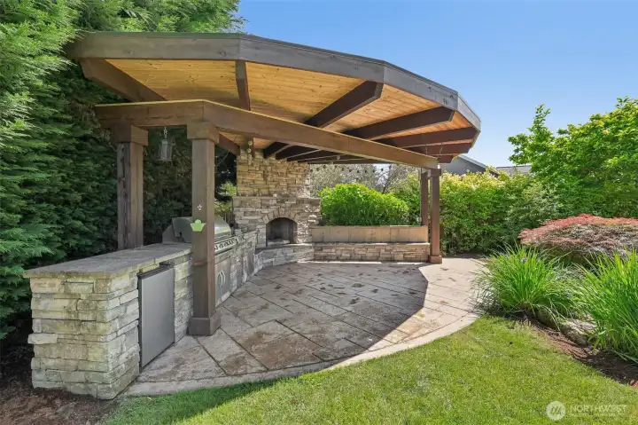Custom Outdoor kitchen with built in BBQ , fridge and fireplace