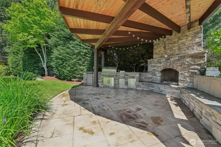 Custom Outdoor kitchen with built in BBQ , fridge and fireplace