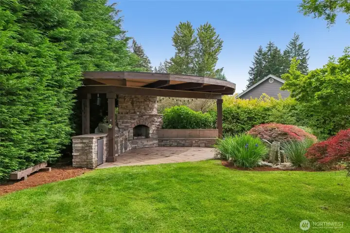 Custom Outdoor kitchen with built in BBQ , fridge and fireplace