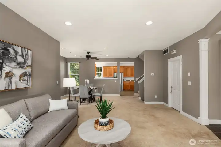 Main floor living room, dining room and guest powder room on the right.