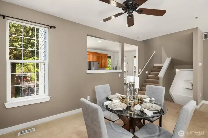 Dining room with a ceiling fan and a door to the front deck.