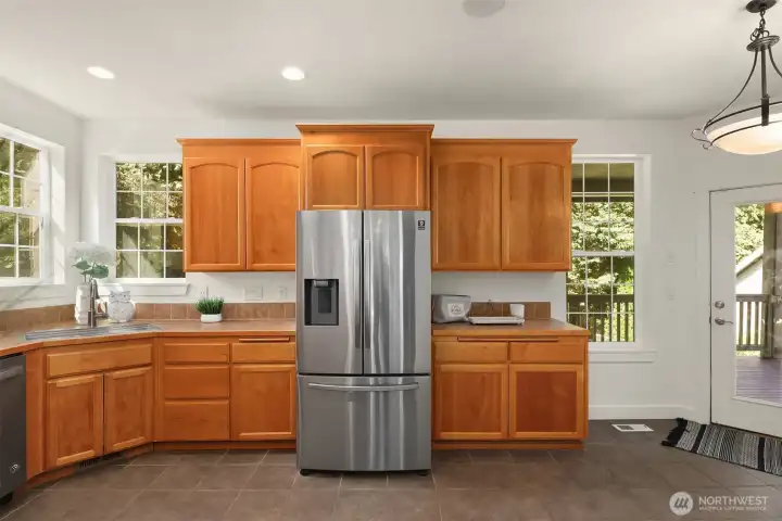 Main floor kitchen with a stainless steel refrigerator.  All appliances will remain.