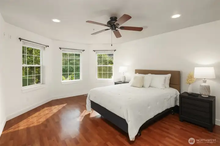 Primary Bedroom on the upper level.  Ceiling fan, bay windows and laminate flooring.