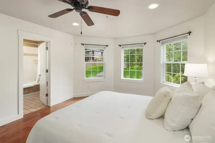 French double doors, a walk in closet and an attached full bathroom.