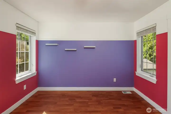 Upper level 2nd bedroom with double closet doors.   Notice the laminate flooring.