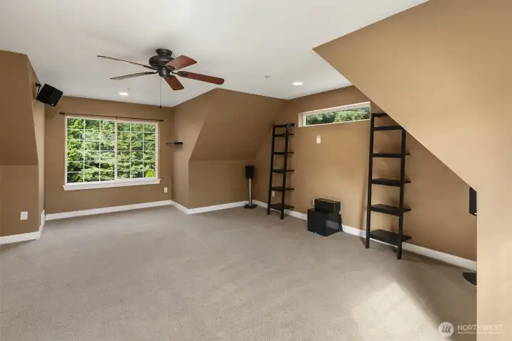 Upper level bonus room with a ceiling fan, built in speakers and  great views of the backyard.