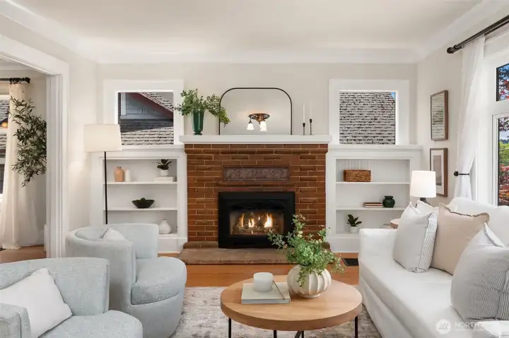 Beautiful fireplace anchors the living room with built-ins and windows on display. Beautiful fireplace anchors the living room with built-ins and windows on display.