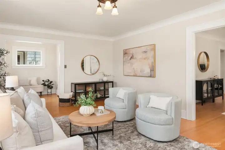 Generous living room with crown molding and refinished wood floors. Generous living room with crown molding and refinished wood floors.