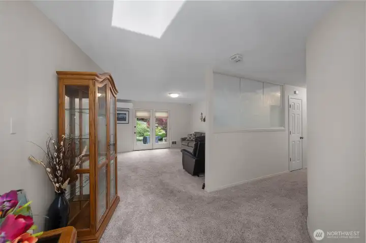 Welcoming entry with a skylight, decorative glass front door, and spacious foyer that sets the tone for the home. Welcoming entry with a skylight, decorative glass front door, and spacious foyer that sets the tone for the home.