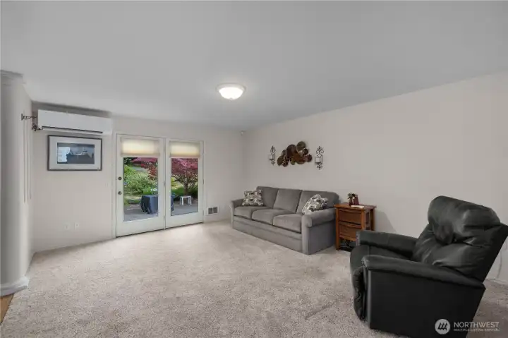 Spacious great room features plush carpeting, abundant natural light, and direct patio access. Spacious great room features plush carpeting, abundant natural light, and direct patio access.