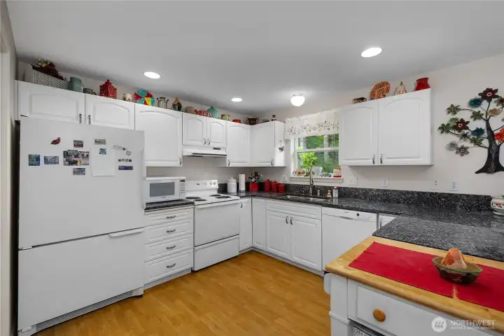 Granite countertops, generous cabinetry, and ample prep space make this kitchen both functional and inviting. Granite countertops, generous cabinetry, and ample prep space make this kitchen both functional and inviting.
