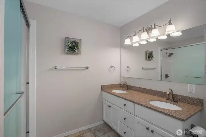 PBa - Primary bath features dual sinks, generous vanity space, updated lighting, and a walk-in shower. PBa - Primary bath features dual sinks, generous vanity space, updated lighting, and a walk-in shower.