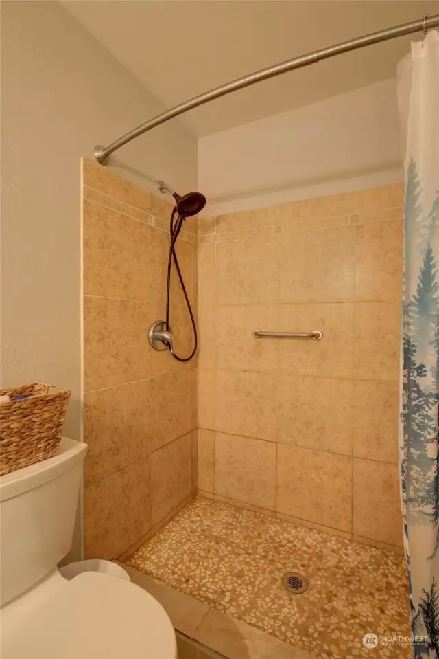 Beautiful, tiled step in shower in primary bathroom.