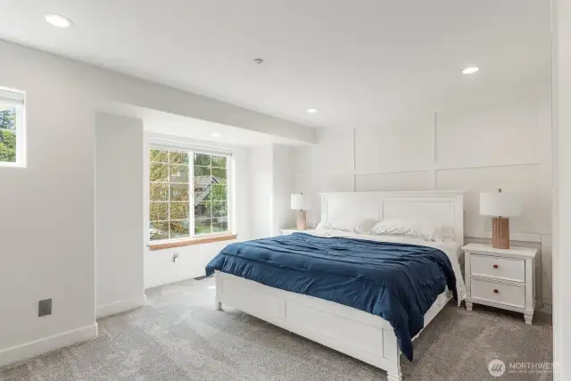 Large Primary Bedroom with lots of lighting.