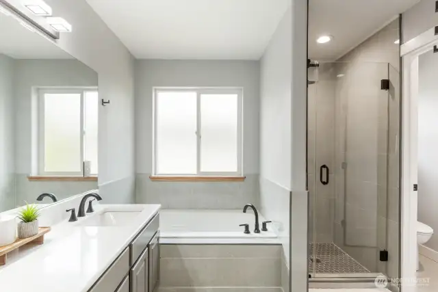 Separate bathtub with walk in shower.