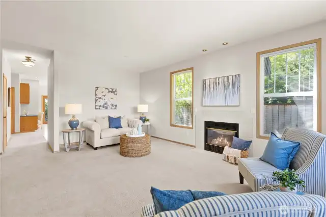 Large windows, towering ceilings, and gas fireplace