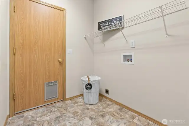 Laundry room with door to garage