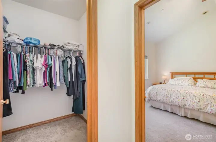 Primary bedroom features vaulted ceilings, recessed lighting, and dual walk-in closets.
